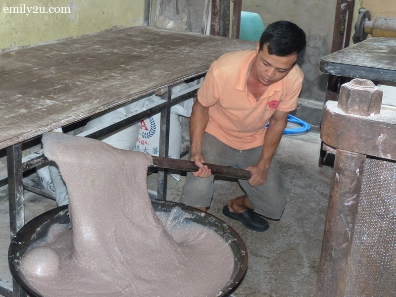 3. a worker stirs the glutinous rice mixture for two hours non-stop