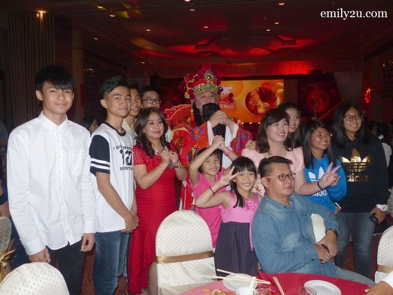 10. The God of Prosperity has arrived! Here's a family photo of Syeun Hotel Director Maggie Ong (in red dress). Huat ah!