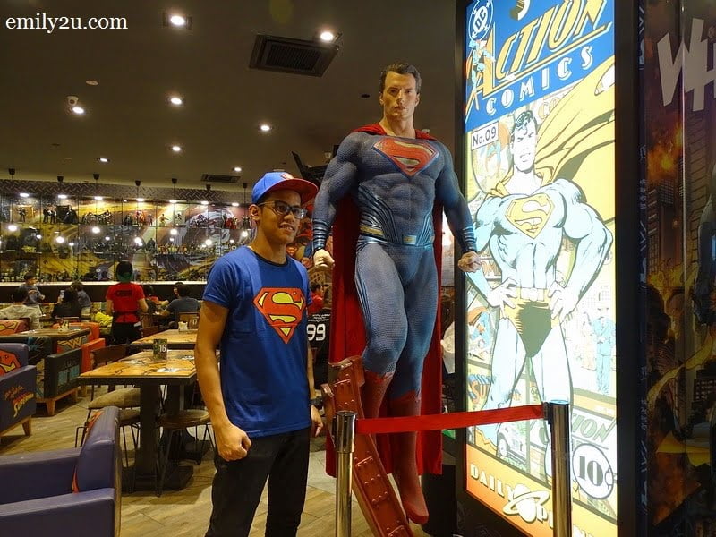  2. a server poses with a life-size Superman