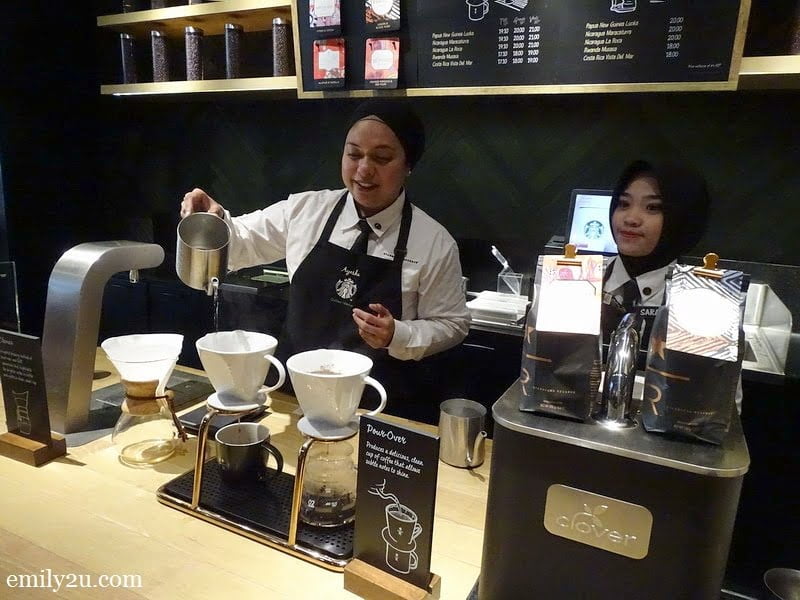 5. Starbucks Ambassador Ayesha brews coffee using the Pour-Over technique, assisted by Sarah