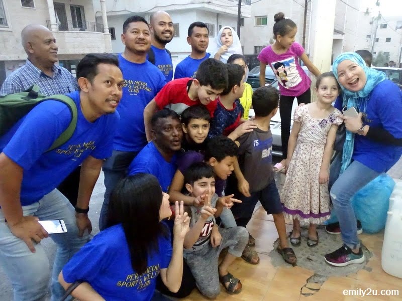 10. taking a photo with Syrian refugee children