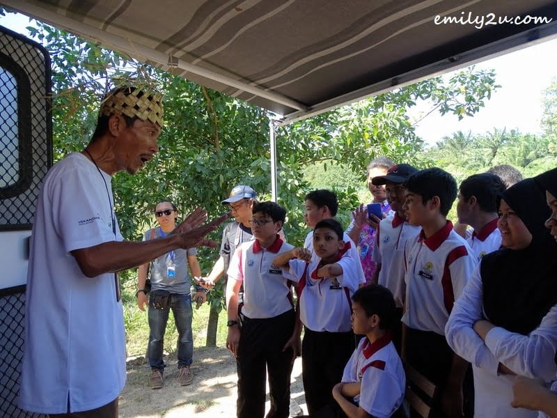  10. nature guide briefs these school children on treasures of the forest