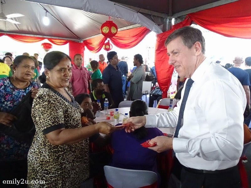 18. Dairy Farm Group's Group Chief Executive Officer Mr. Ian Mcleod (R) distributes angpow to recipients of MyKasih aid