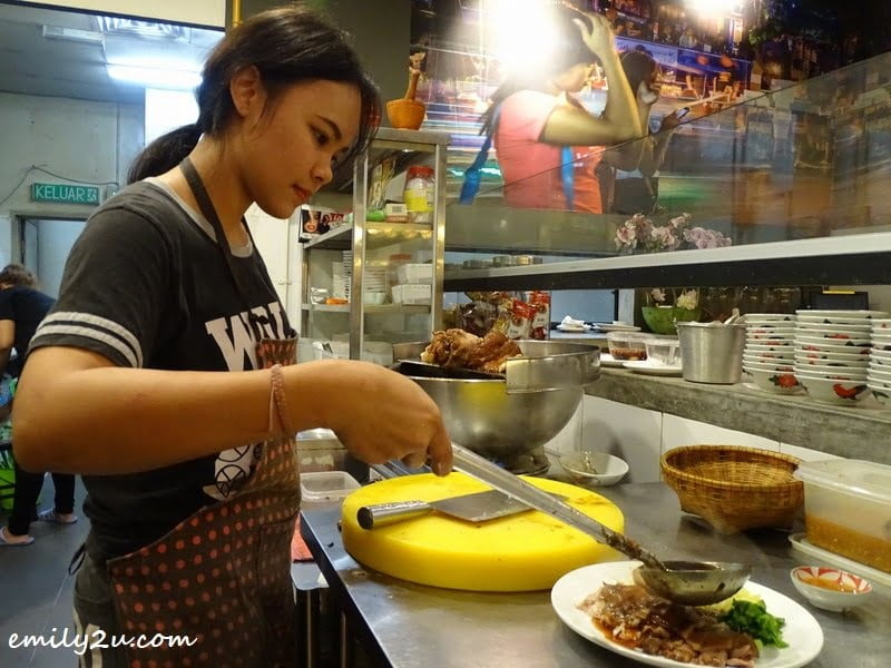 8. pouring sauce over Khao Kha Moo (stewed pork leg)