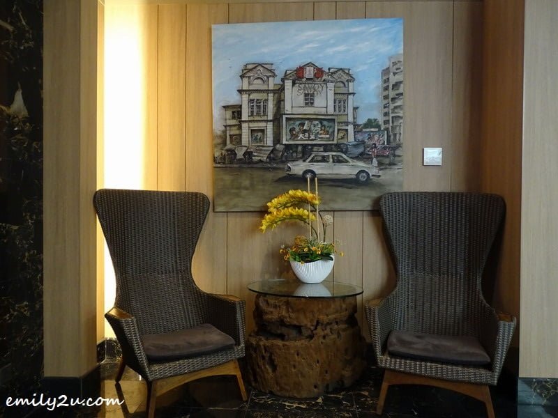  3. cosy corner with a painting of the original business of ibis Melaka, a cinema