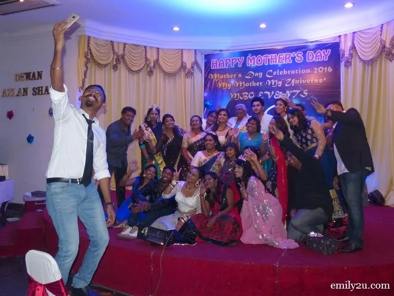 22. the emcee takes a group shot 