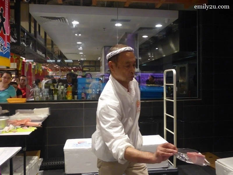 3. Chef Isobe weighs a slice of tuna