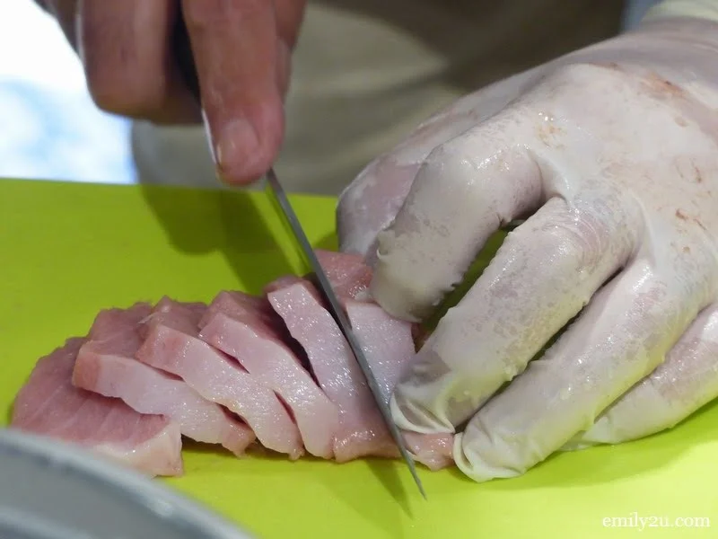 5. Chef Isobe prepares the tuna sashimi for customers
