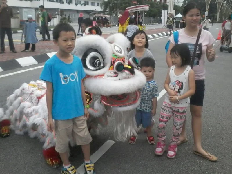4. a young family takes the chance to pose with the lion