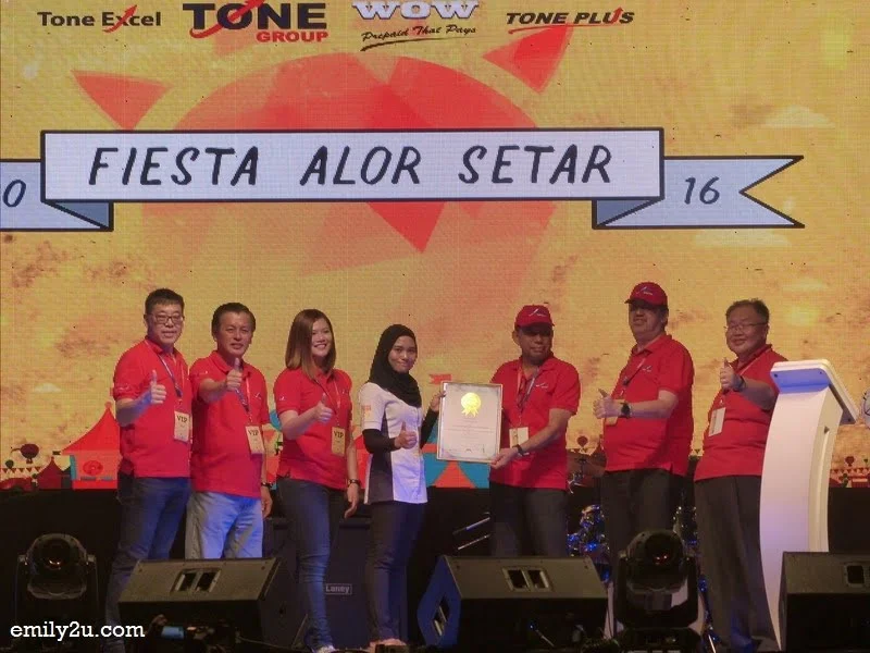 12. Nurasyikin Ramli (Senior Research Journalist, The Malaysia Book of Records) presents the certificate to Chairman of Tone Group, Dato' Syed Kamaruzaman Syed Abdullah, looked on by other company directors