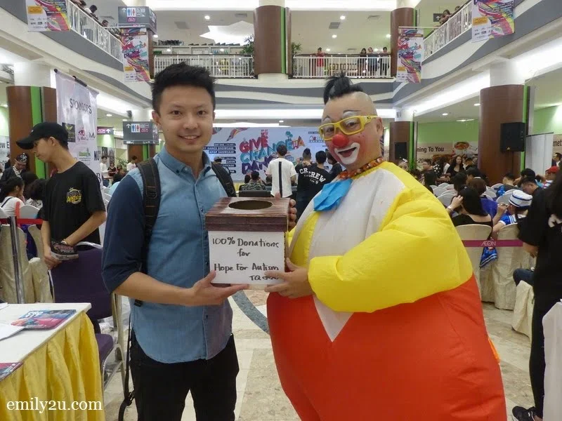 12. Au Young the Clown donates his takings to a representative from Hope For Autism Society
