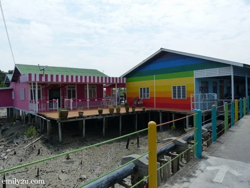 16. the island village is drab and gray, so houses are painted like rainbows and candies