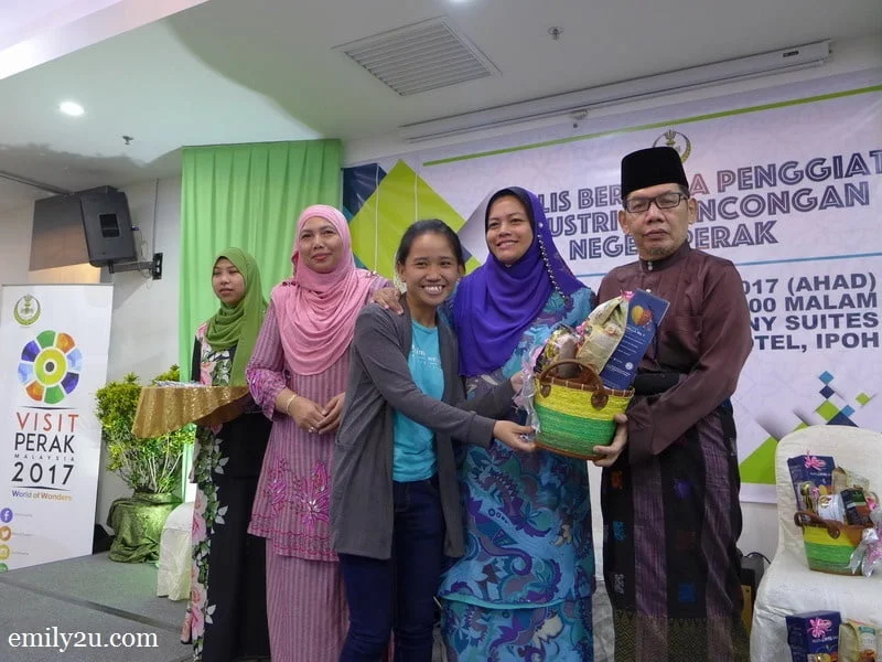 3. a reporter is all smiles receiving her Hari Raya hamper