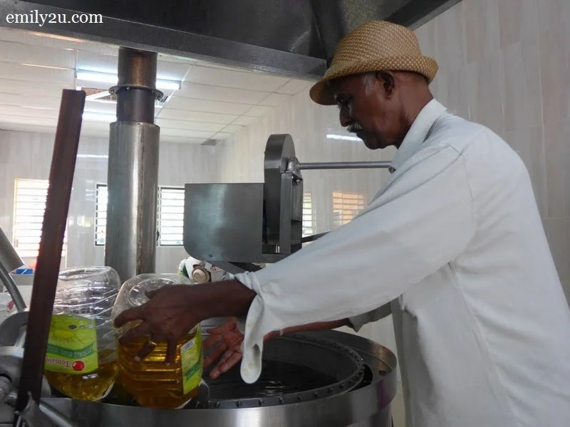 6. Jayabalan adds oil into the fryer