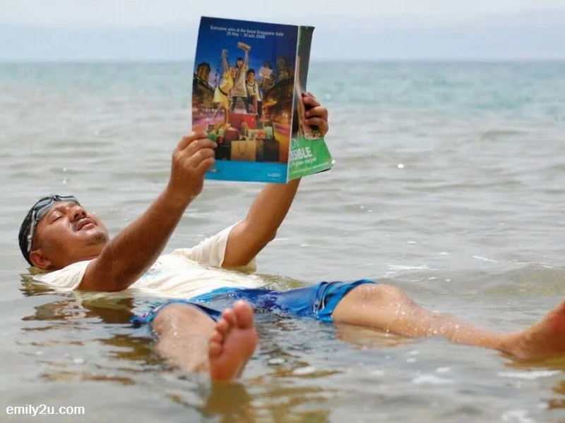 9. KSKMP adviser-cum-delegation leader, Datuk Akmar Hisham Mokhles reads a magazine while floating in the Dead Sea