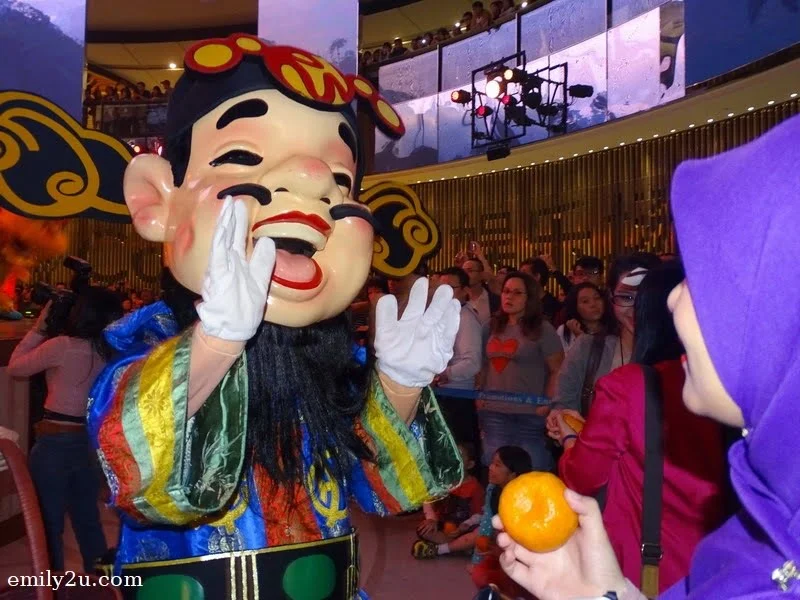  5. one of the six Gods of Prosperity interacting with visitors