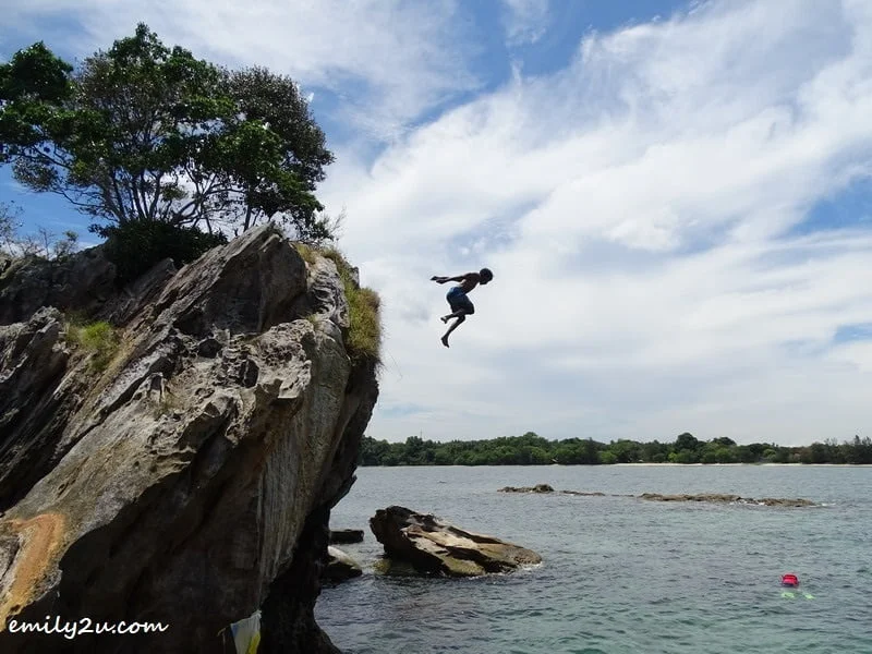 13. a holiday-maker takes a plunge into the sea