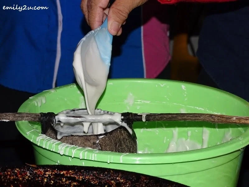 5. scoop kuih jala mixture into coconut shell