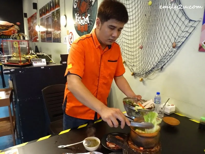 5. Chin adds ingredients into the Thai hot pot