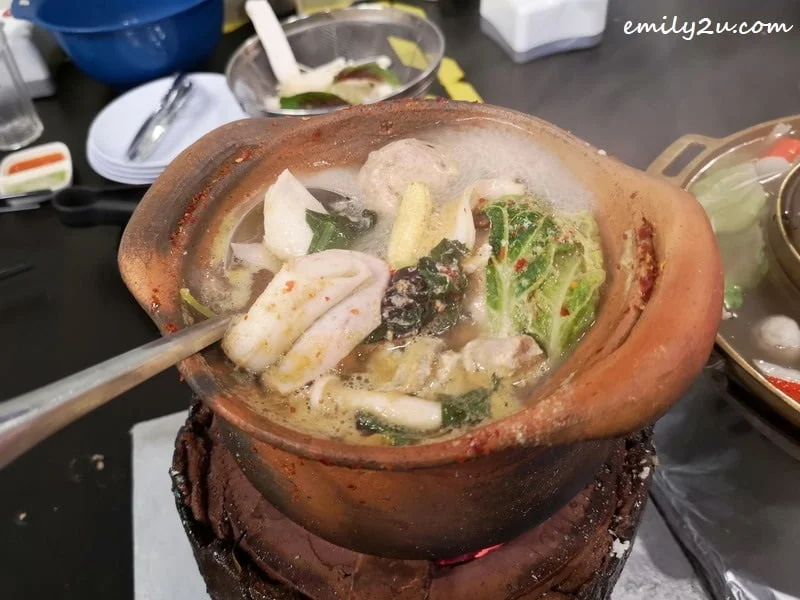 6. bringing ingredients to a boil in the Thai Hot Pot with clear broth