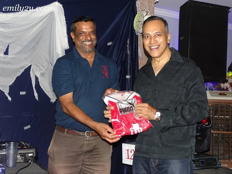 18. Louis Sebastian (R) with his limited edition Arsenal FC prize won in a lucky draw