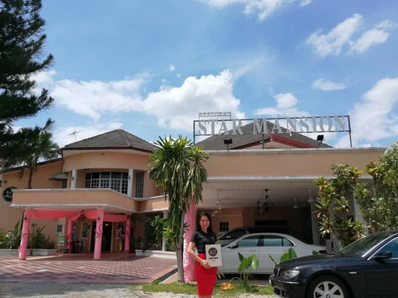 1. proprietor Ms. Christy Tan in front of Star Mansion