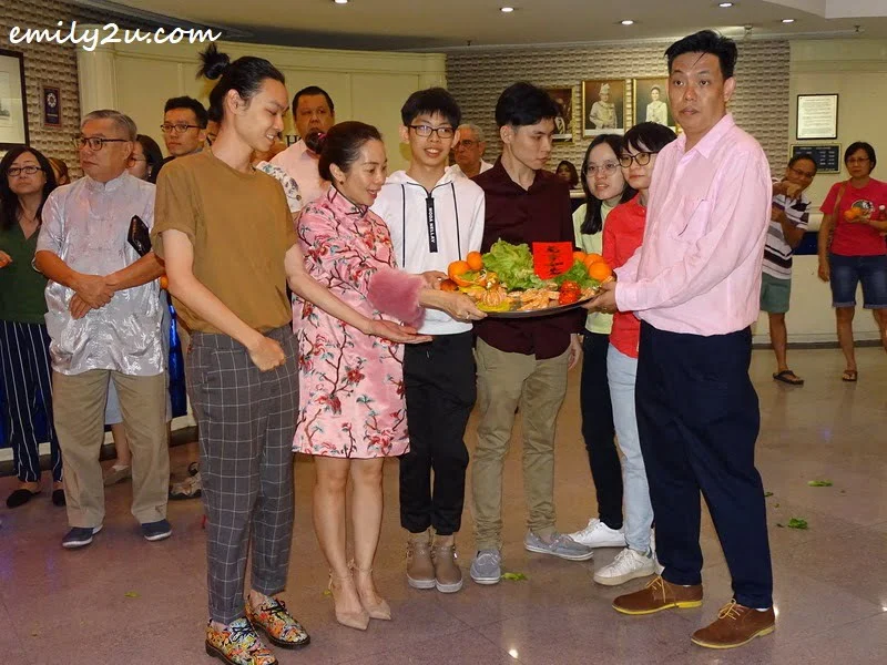 12. hotel director Mr Yan (R), Ms Elena Phor (second L), their family and friends with the good luck platter received from the lions