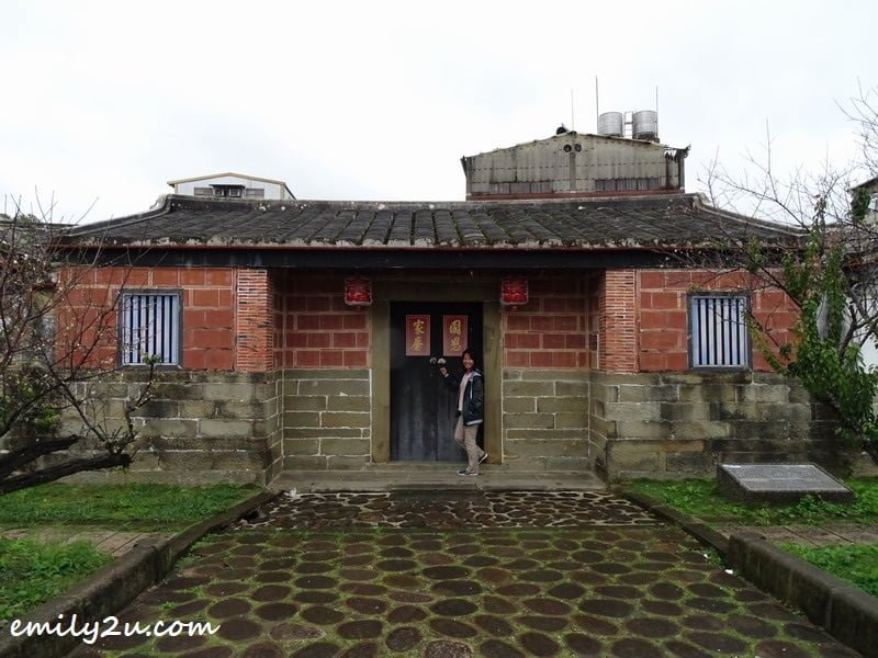 2 posing in front of a typical Hakka house in Beipu, Hsinchu County