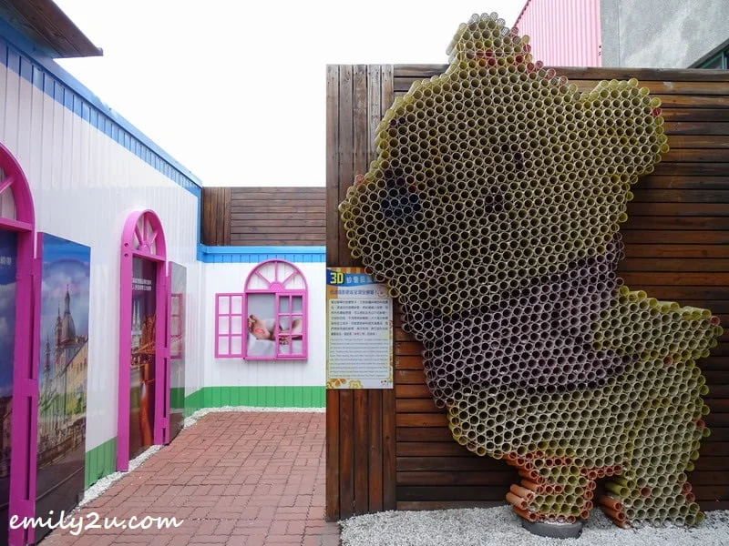 Winnie The Pooh land art made from plastic tubes of material yarn