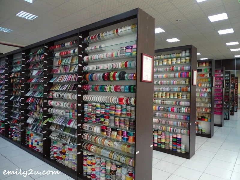 ribbons are arranged on shelves according to type and colours, like books in a library at Ribbon Museum
