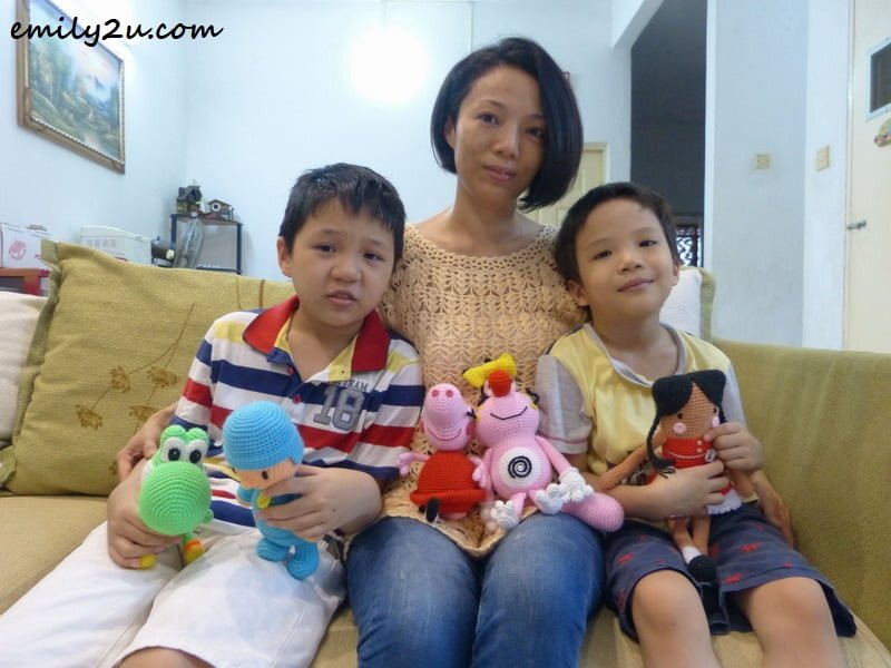 With sons Gordon (L) & Malcolm (R) and Amigurumi items (L-R): Yoshi (a character from Mario Bros), Pocoyo, Peppa Pig, Olivia (a character from the cartoon Oggy & The Cockroaches) and Cahaya Doll (a customisable doll)