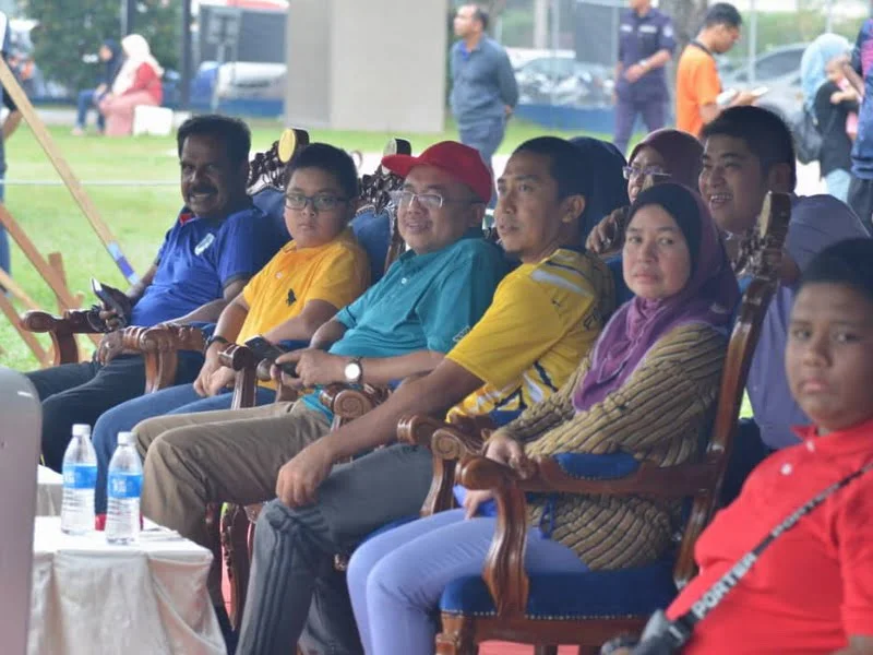 Ipoh City Mayor Dato' Ahmad Suaidi (in red cap) watches the game