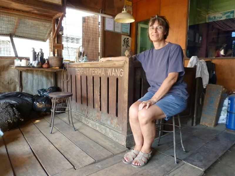 Liz at the counter of a shop that buys rubber in Lenggong