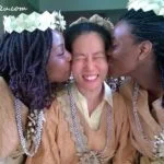 writer as bride in the mock wedding kissed by visitors from France