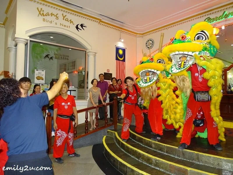 the lions share blessings with well-wishers by tossing mandarin oranges