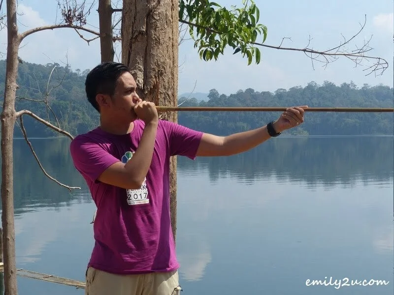 trying out the blowpipe at Kampung Aman Damai, Royal Belum