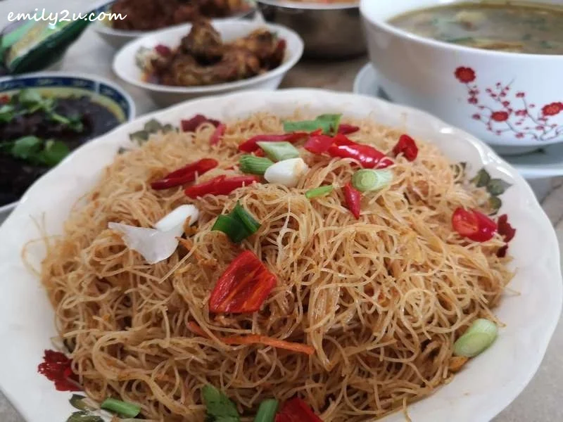Tom Yam Mee Hoon garnished with chilli and spring onions