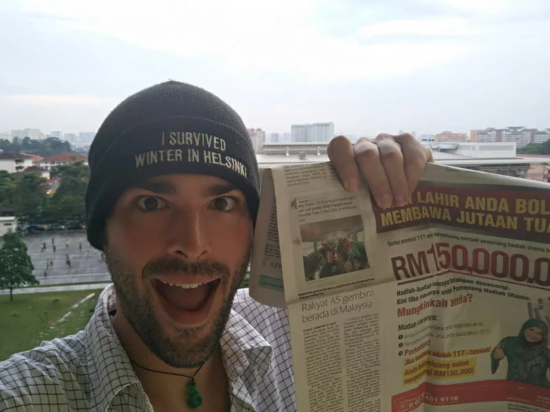 holding up the first newspaper article after Freal's tweet went viral