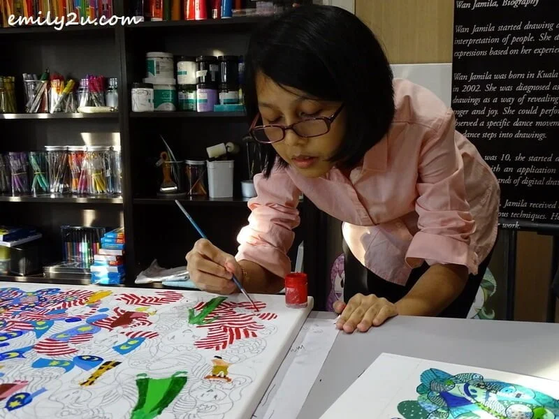 Jamila concentrates on her painting