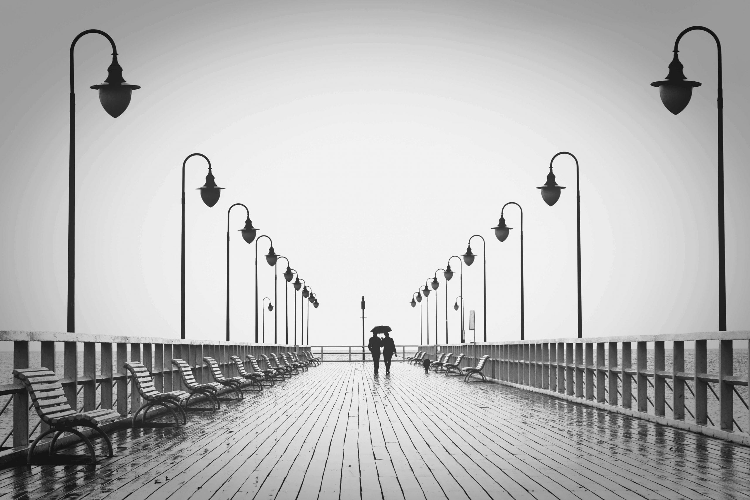 Photo by Pixabay: two people walking on pier