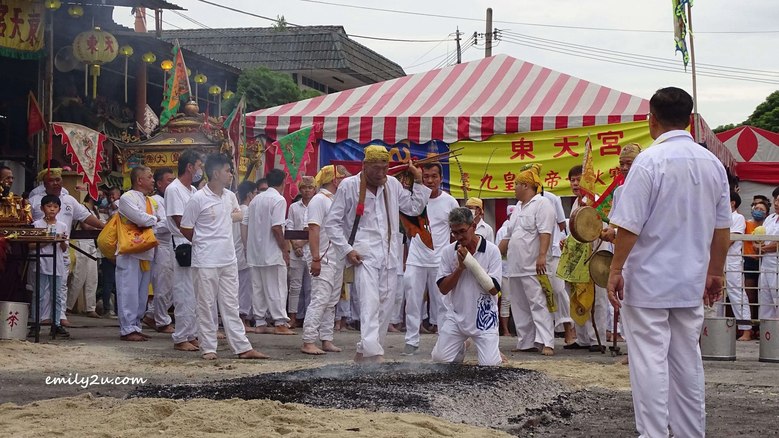 blessing one of the devotees before he walks across the fire
