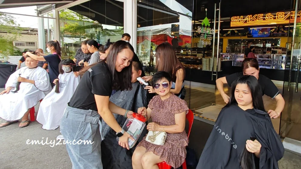 Shake & Bake Cafe co-owner, Mrs Patrick Ewe (seated), donates cash