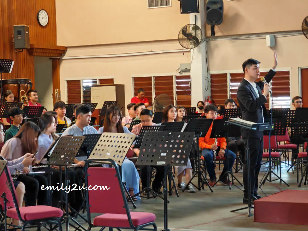 Kinta Valley Wind Orchestra conductor Aaron Chin introduces his musiciains