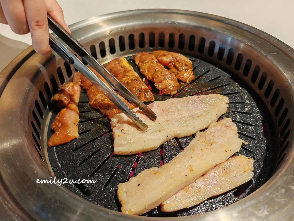 placing meat on the grill 