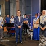 Tan Sri Dato' Seri Dr. Jeffrey Cheah (Founder & Chairman of Sunway Group) & Dato' Nolee Ashilin Mohammed Radzi (event organising Chairperson) pose with the Chinese orchestra of Nam Hoi Association