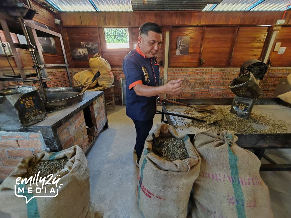 Joe Chan, Project Executive at Chang Jiang White Coffee, leads visitors during a tour of the coffee brewery gallery on the official opening day