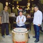 Martin Yan tries his hand at the traditional Chinese drum