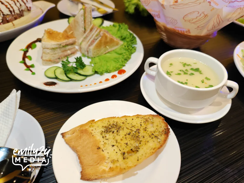 Chicken Soup with a slice of Garlic Bread