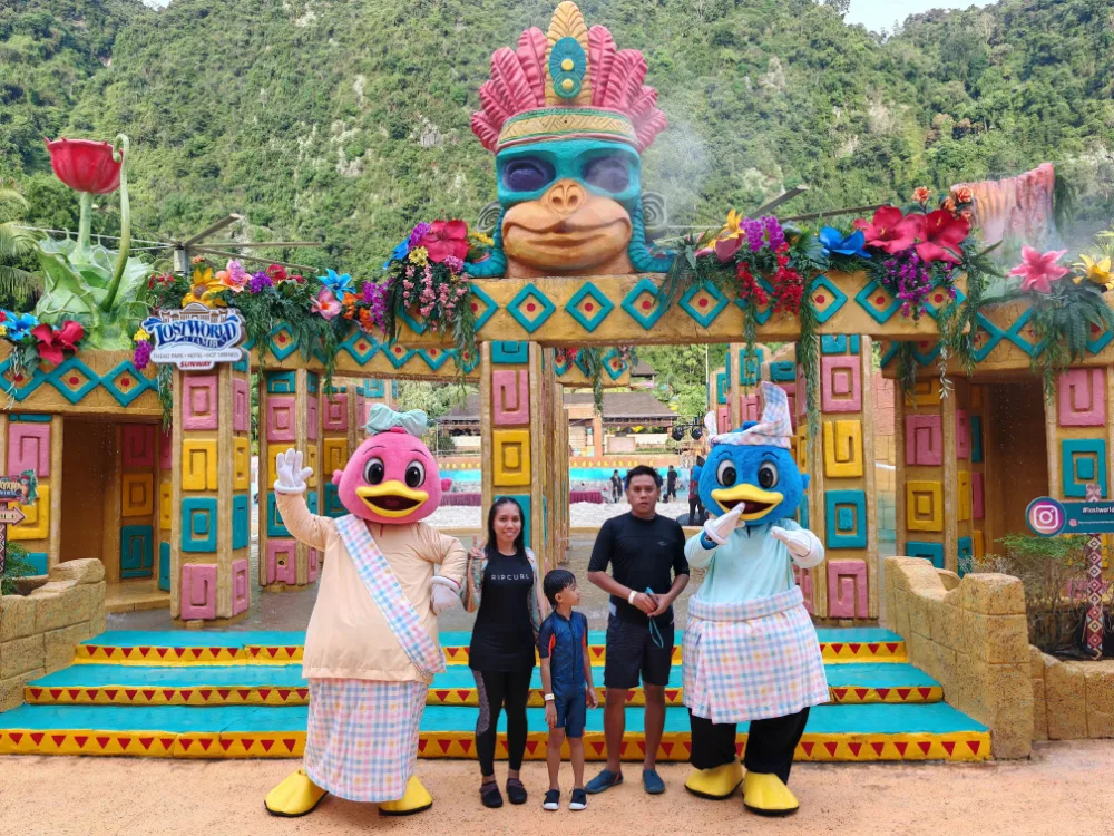 a family takes the opportunity to pose for a photo with Captain Quack and Lady Quack