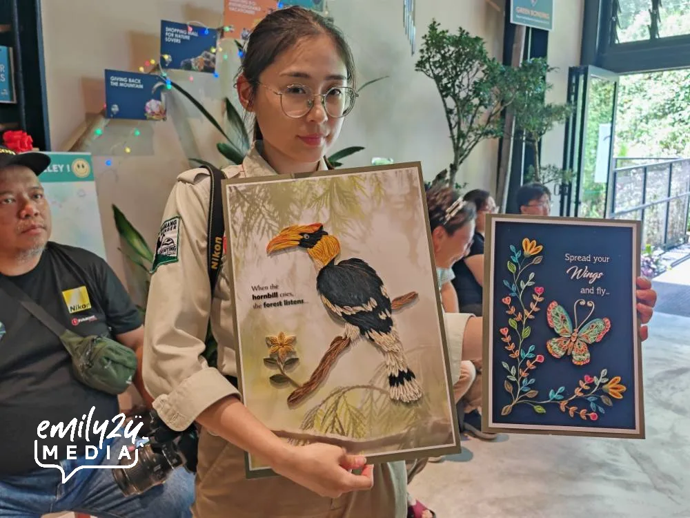 GNA Resident Naturalist Executive Boey Yen Li holds two pieces of nature-inspired handicraft from Quilljoy Endeavours